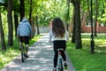 Young sporty couple riding on mountain bicycle on the road. Back view