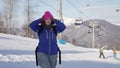 young sporty female tourist is visiting ski resort, portrait of skier or snowboarder woman Royalty Free Stock Photo