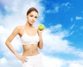 Young, sporty, fit and beautiful girl with the apple isolated on