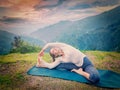 Young sporty fit woman doing Hatha Yoga asana