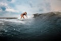 Young girl gliding on a wakeboard in the river near forest Royalty Free Stock Photo