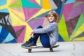 Young sporty girl riding on longboard in park.