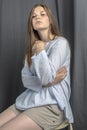 Young sporty girl in white blouse resting on a bench