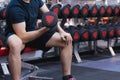 Young sporty man doing dumbbell curl in gym. Sport and exercise concept