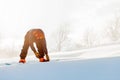 Young sporty man fastening the snowboard before the contest