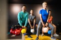 Young sporty people working out together with kettle bells in a gym. Royalty Free Stock Photo