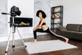 An African-American woman records yoga classes Royalty Free Stock Photo