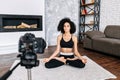 An African-American woman records yoga classes Royalty Free Stock Photo