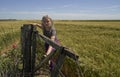 Young sporty woman, does stretching exercise in wheat field Royalty Free Stock Photo