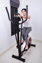 Sporty woman doing exercises with elliptical trainer Royalty Free Stock Photo