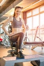 Young sporty woman doing lunges over fitness stepper at gym. Royalty Free Stock Photo