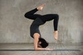 Young sporty woman doing Pincha Mayurasana exercise Royalty Free Stock Photo