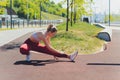 Young Sporty woman doing stretching exercise promenade. Royalty Free Stock Photo