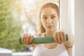 Sporty woman doing stretching exercises with torsion at home