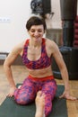 Young sporty woman doing Tiryam-Mukha Eka-Pada Paschimottanasana