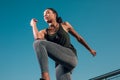 Jumping and touching knee with elbow stock photo