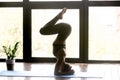 Young sporty woman doing yoga headstand exercise Royalty Free Stock Photo