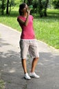 Young sporty woman drinking water