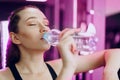 Young sporty woman drinking water in a gym Royalty Free Stock Photo