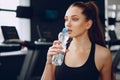 Young sporty woman drinking water in a gym Royalty Free Stock Photo