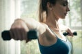 Young sporty woman exercising with dumbbells at home Royalty Free Stock Photo