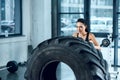 young sporty woman flipping workout wheel