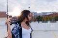 Young sporty woman holding longboard behind in sunset Royalty Free Stock Photo