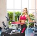 Young sporty woman with hula hoop at gym Royalty Free Stock Photo