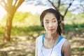 Young sporty woman listening music with headphone in park Royalty Free Stock Photo