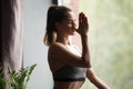 Young sporty woman in nadi shodhana pranayama pose