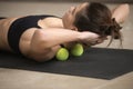 Young sporty woman practicing self-massage technique with tennis Royalty Free Stock Photo