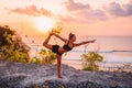 Young sporty woman practicing yoga at bright sunset time Royalty Free Stock Photo