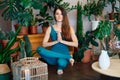 Young sporty woman practicing yoga doing half lotus toe balance pose at home