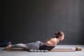 Sporty woman practicing yoga, doing Salabhasana pose variation