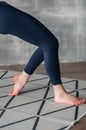 Young sporty woman practicing yoga lesson sitting in Sukhasana exercise, Easy Seat pose with mudra gesture, working out, female Royalty Free Stock Photo