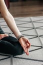 Young sporty woman practicing yoga lesson sitting in Sukhasana exercise, Easy Seat pose with mudra gesture, working out, female Royalty Free Stock Photo