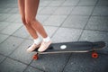 Young sporty woman riding on the longboard in the park. Royalty Free Stock Photo