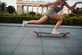 Young sporty woman riding on the longboard in the park. Royalty Free Stock Photo