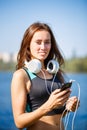 Young sporty woman with smartphone on training Royalty Free Stock Photo