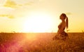 Sporty woman at sunset in wheat field Royalty Free Stock Photo