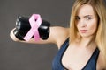 Woman wearing boxing gloves having pink ribbon Royalty Free Stock Photo