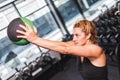 Young sporty woman working out with a ball