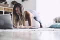 Young sporty woman working out at home, teenager doing fitness exercises on living room floor for buttocks body shaping Royalty Free Stock Photo