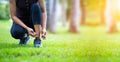 Young sporty women are tied with running shoes to run exercise in the morning..Portrait of beautiful Women exercising in the park Royalty Free Stock Photo