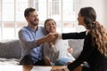 Young spouse shaking hands with professional financial consultant. Royalty Free Stock Photo