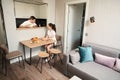 Young spouses chat at breakfast in the kitchen area