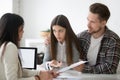 Young spouses having dispute about house buying with realtor Royalty Free Stock Photo