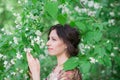 Young spring fashion woman in spring garden. Beautiful girl in spring landscape background. Allergic to pollen of flowers. Female Royalty Free Stock Photo