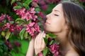 Young spring fashion woman in spring garden Springtime Summertime Trendy girl in the flowering trees in then at sunset in spring Royalty Free Stock Photo