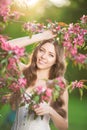 Young spring fashion woman in spring garden Springtime Summertime Trendy girl in the flowering trees in then at sunset in spring Royalty Free Stock Photo